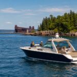 Private Marquette boat tour cruising on Lake Superior near the harbor lighthouse